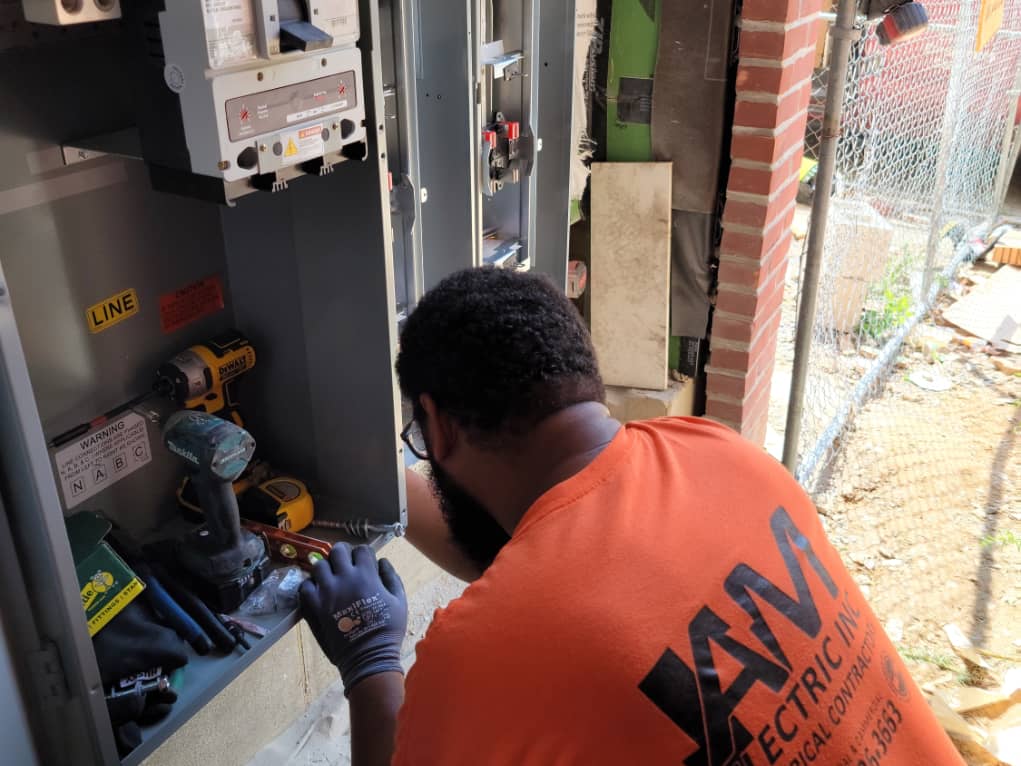 am eletric's electrician installing 9 gang meter