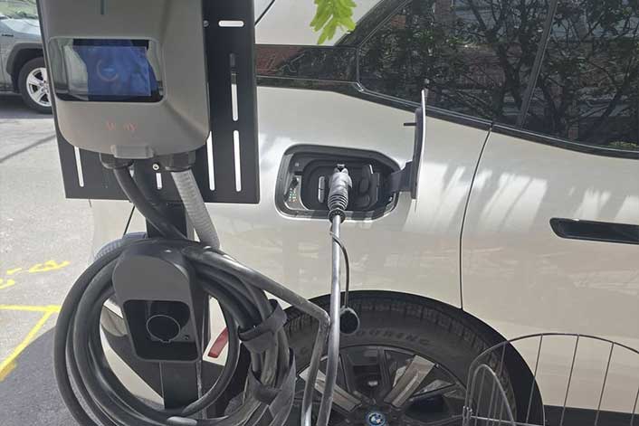 AM Electric team member installing an EV charging station